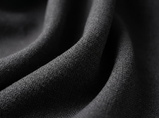 Heavier woven cloth close-up. GSM is the mass of one square meter of cloth, not a yarn count.