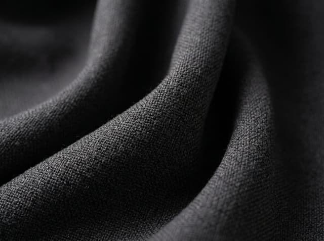 Heavier woven cloth close-up. GSM is the mass of one square meter of cloth, not a yarn count.