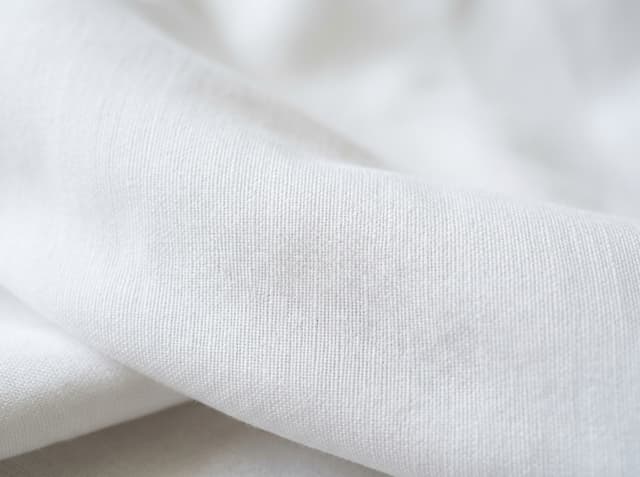 Prepared white cloth after scouring and bleaching — the dye-ready look buyers mean by PFD, not a finished shade.